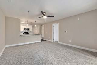 spacious living room with a ceiling fan  at Signature Pointe Apartment Homes, Athens, AL