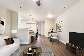 living, dining, and kitchen areas with hard surface floors at Signature Pointe Apartment Homes in Athens, AL