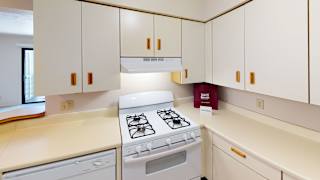 a kitchen with a white dishwasher and gas stove at South Bridge Apartments, Fort Wayne, Indiana