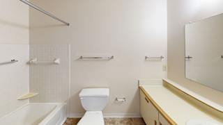 A bathroom with a bathtub and shower at South Bridge Apartments, Fort Wayne