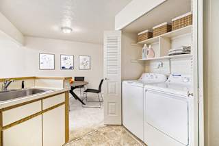 A kitchen with a washer and dryer at South Bridge Apartments, Indiana
