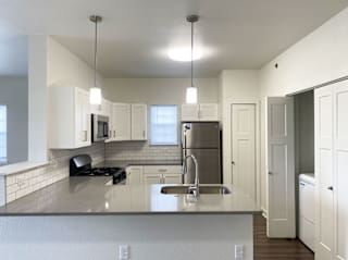 a kitchen with a window and washer and dryer at Stoney Pointe Apartment Homes, Wichita, KS