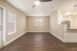 enlarged living room with hard surface flooring and an extra window at Stoney Pointe Apartment Homes, Kansas