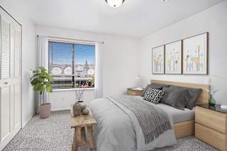 A bedroom with a large bed, a window and a large closet at Stoney Pointe Apartment Homes, Wichita