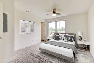 a bedroom with a bed and a ceiling fan at Stoney Pointe Apartment Homes, Kansas