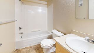 a bathroom with a sink toilet and a tub at Swiss Valley Apartments, Wyoming, MI, 49509