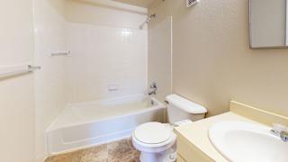 a bathroom with a toilet and a tub and a sink at Swiss Valley Apartments, Michigan