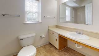 A bathroom with a window at Tall Oaks Apartment Homes, Kalamazoo, MI