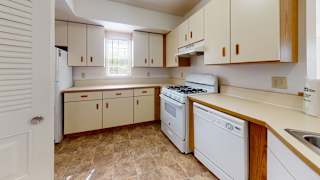 A kitchen with a window and white appliances at Tall Oaks Apartment Homes, Michigan, 49009