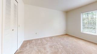 Bedroom with large window at Tall Oaks Apartment Homes, Michigan, 49009