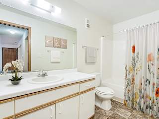 A spacious bathroom with a large vanity  at Tanglewood Apartments, Oak Creek, WI