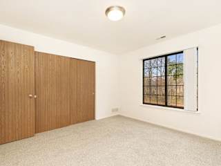 bedroom with large window and closet at Tanglewood Apartments, Oak Creek, WI