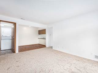 dining room with a kitchen and closet with washer and dryer at Tanglewood Apartments, Oak Creek, WI
