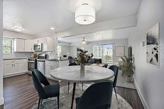an open kitchen and dining room with a table and chairs at The Crossings Apartments in Grand Rapids, MI