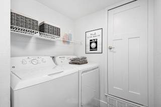 laundry room with a washer and dryer at The Crossings Apartments, Michigan, 49508