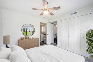 a bedroom with a ceiling fan at The Crossings Apartments, Michigan, 49508
