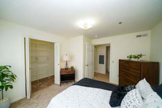 A bedroom with a walk-in closet at Tracy Creek Apartment Homes, Perrysburg, OH, 43551