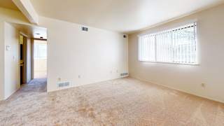 A garden style living room with carpeting at Walnut Trail Apartments, Portage, 49002