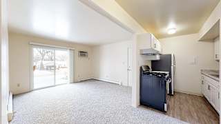An upgraded kitchen and living room with access to a patio at Wood Creek Apartments, Kenosha, WI, 53144