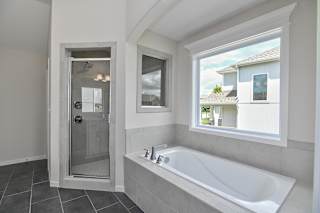 A bathroom with a tub and a window.