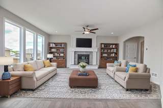 A living room with a fireplace, two couches, and a coffee table.