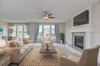 A living room with a fireplace and a television mounted on the wall.