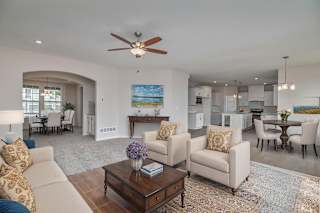 A living room with a white couch and a coffee table.