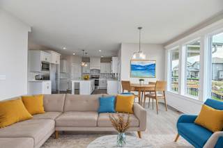 A living room with a grey couch and a blue chair.