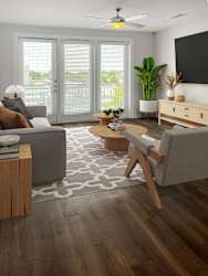 A living room with a grey couch, a wooden coffee table, and a ceiling fan.