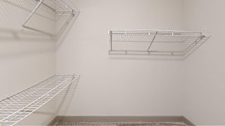 Empty wire shelving in a room.
