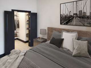 A bedroom with a large bed and a bridge picture on the wall.