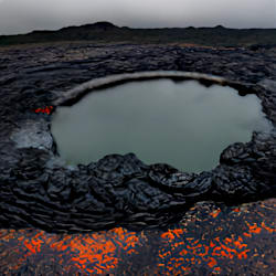 a geyser in the middle of a lava field