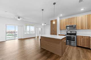 A kitchen with wooden cabinets and a stainless steel oven.