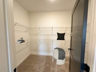 Walk-in closet with white wire shelving system 4 at The Wren Apartments, Lawrenceville