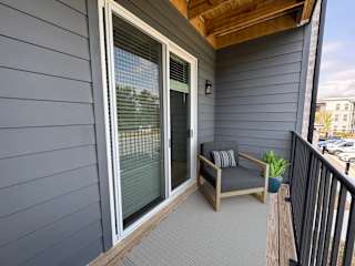 Private balcony with lounge chair and planters at The Wren Apartments, Lawrenceville, Georgia