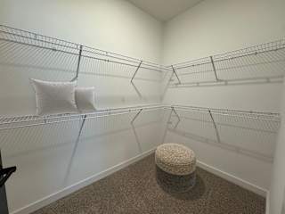 Spacious walk-in closet with wire shelving system at The Wren Apartments, Lawrenceville, GA 30043