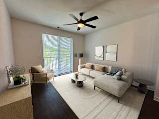 Modern living room with sectional sofa and ceiling fan at The Wren Apartments, Lawrenceville, Georgia