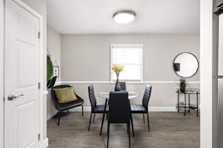 A dining room with a table set for four.