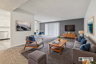A living room with a sofa, chairs, and a coffee table.