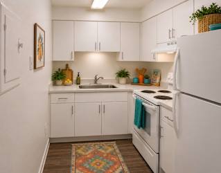 A kitchen with white appliances and cabinets.