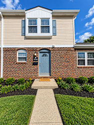 A house with a blue door and a sign that says "1175" on it.