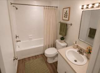 A bathroom with a white toilet, a white sink, and a white bathtub.
