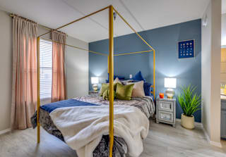 a bedroom with a gold canopy bed