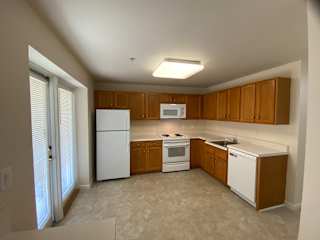 Fully equipped, open space kitchen with patio entrance