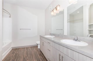 Bathroom with sink and mirror at One White Oak Apartments, Cumming, Georgia