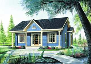a blue house with a yard and a tree