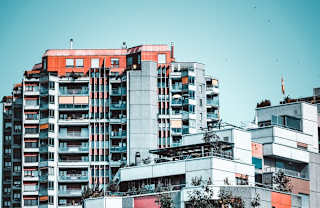 a group of tall buildings with a sky background