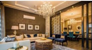 a living room filled with furniture and a chandelier