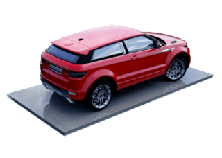A red car is shown from the rear view on a grey platform.