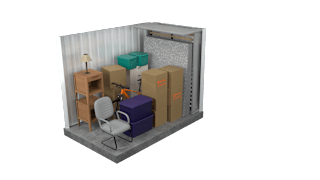 A chair is placed in front of a small table and some boxes in a room.